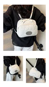 Sac fourre-tout blanc avec broderie florale montrant des bretelles sac à dos et bandoulière