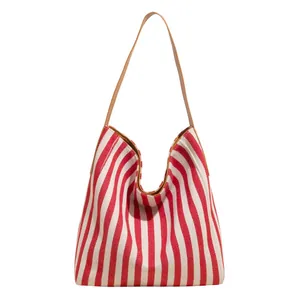 Large striped canvas tote bag with red and white vertical lines and brown strap