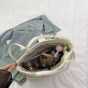 Quilted white tote bag with large capacity showing organized internal storage space