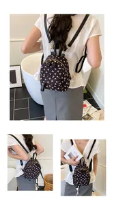Detailed views of mini black quilted backpack with white bow patterns on model
