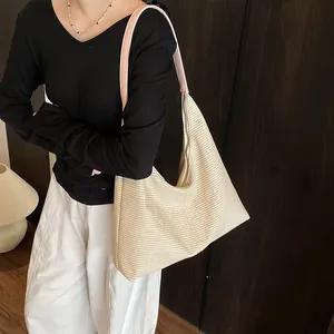 Fashionable straw bucket bag with pink straps and embossed letters for summer vacation