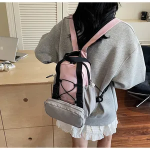 Pink and grey multi-functional backpack detail with a small detachable front pouch