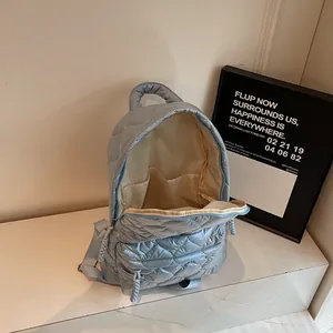 Light blue quilted large backpack with spacious interior pockets and nylon texture