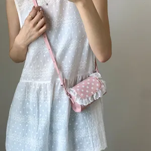 Pink lace polka dot mini shoulder bag for women shown as a stylish crossbody bag
