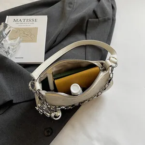 Chic cream leather underarm bag with silver chain and large capacity interior space