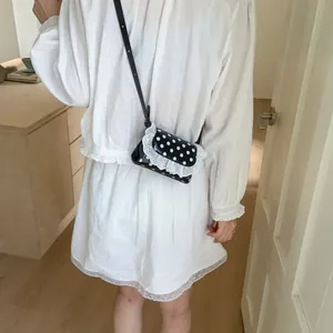 Mini lace polka dot crossbody bag with black shiny leather for elegant casual style