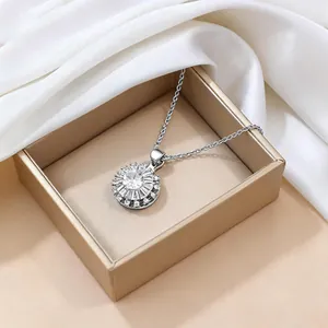 Close-up of a rotating zircon flower pendant necklace in a premium gold jewelry gift box
