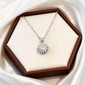 Close-up of a silver flower necklace with rotating zircon pendant in a brown jewelry box