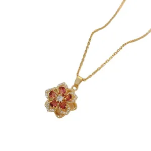 Rotating flower pendant necklace in gold with orange gemstones and white zircon accents