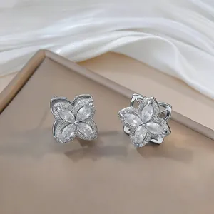 Elegant silver flower earrings with zircon inlays displayed on a premium display stand