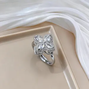 Macro shot of silver clover ring with marquise-cut zircons and pavé diamond detailing