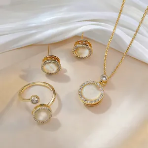 Elegant gold titanium steel jewelry set featuring rotatable cat eye stone and zircon accents
