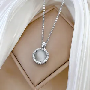 Rotating cat-eye stone necklace in titanium steel with shimmering zircon circle pendant