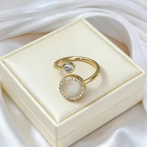 Macro detail of adjustable gold ring with rotating cat eye stone and pavé crystal trim