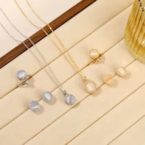 Elegant titanium steel jewelry set with rotating cat-eye stones and zircon halo in gold and silver
