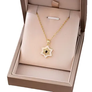 Golden necklace featuring a star pendant with white enamel and sparkling zircon accents