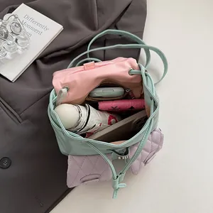 Mini macaron quilted backpack showing spacious interior with phone, wallet and umbrella