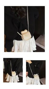 Detail view of mini bow crossbody bag with pink lettering and adjustable shoulder strap