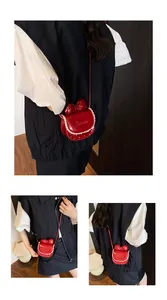 Detail view of mini red crossbody bag with bow, lace trim and white polka dots