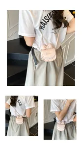 Detailed view of mini pink crossbody bag with bow decoration and Barma lettering