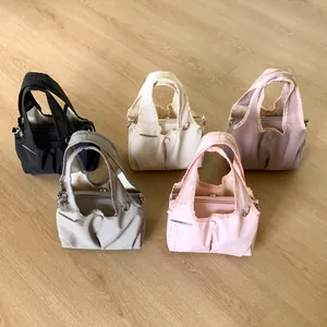 Nylon tote bags in five colors with ruffle trim and dual handles for women