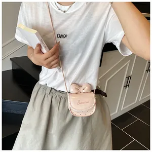 Close-up of pink mini crossbody bag featuring a sweet bow and white lace trim detail