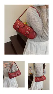 Detalle de bolso de hombro rojo oscuro con dos bolsillos frontales y hebillas plata