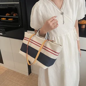 Large striped canvas tote bag with leather straps and nautical design for daily shopping