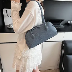 Large denim blue Boston bag for women with contrast stitching in a casual style