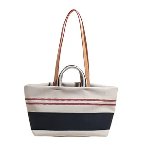 Canvas striped tote bag with red and navy stripes and leather straps for summer shopping