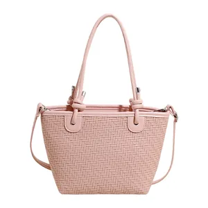 Pink woven texture tote bag with stylish knotted handles for casual summer shoulder wear