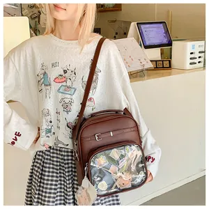 Brown faux leather crossbody bag with a large transparent PVC window for charms