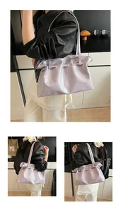 Macro view of lavender oil wax leather tote showing wrinkled texture and fine shoulder strap