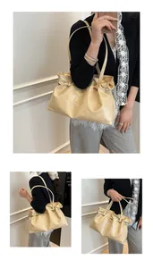 Close-up of cream textured patent leather shoulder bag with cloud pleats and drawstring detail