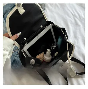 Macro shot of large interior capacity showing organized cosmetics and tablet inside the bag