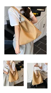 Macro detail of high-quality V-shaped woven texture on a large khaki shoulder tote bag