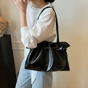 Chic black glossy shoulder bag with drawstring closure and large capacity for women