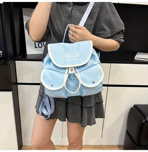 Close-up of light blue nylon backpack featuring white trim and MuOn Shark lettering logo