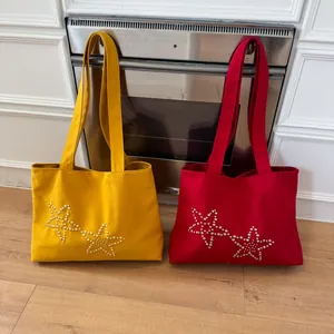 Minimalist canvas tote bag with pearl star patterns in yellow and red colors