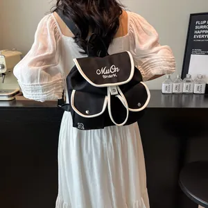 Minimalist black nylon drawstring backpack with white trim and shark embroidery