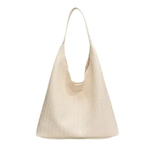 Chic cream woven tote bag with herringbone pattern and spacious hobo shoulder strap design