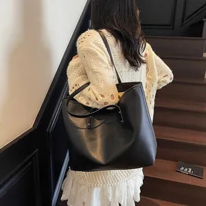 Minimalist black faux leather large capacity tote bag for women commuting and daily use