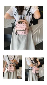 Detailansichten eines rosa gefalteten Mini-Rucksacks mit schwarzen Schleifen-Prints