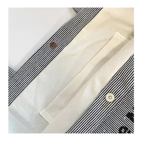 Detail view of canvas tote bag interior with magnetic snap closure and inner pocket