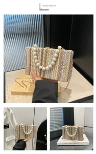 Close-up of woven shoulder bag with large pearl handle and gold chain strap detail
