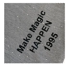 Detail of striped canvas tote with Make Magic HAPPEN print and rhinestone accents