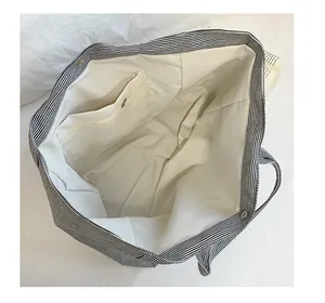 Detail of canvas tote bag interior with zipper pocket and magnetic snap closure