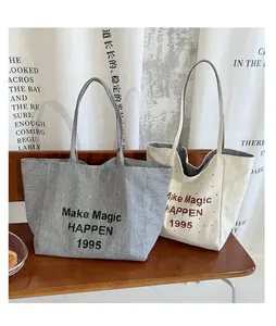 Detail of checkered and polka dot canvas tote bags with Make Magic HAPPEN 1995 print