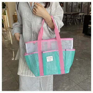 Detail of pink-green mesh tote bag featuring multi-pocket design and Cute Shop label