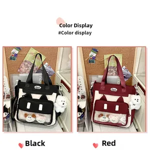 Detail showing cute cat-ear shaped clear windows and plush charms on tote bags
